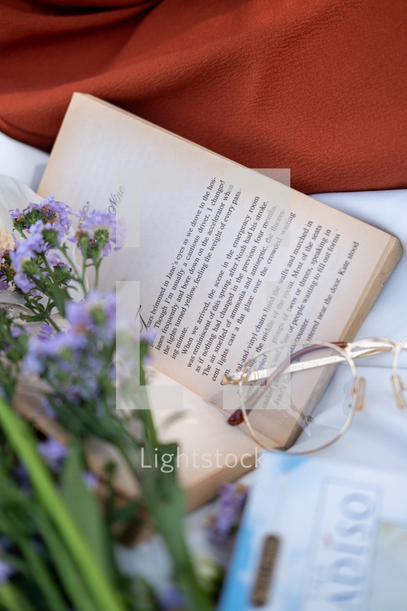 book, flowers, and reading glasses 