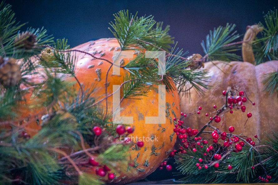 Fall Christmas decorations with berries, greenery, pumpkins and fruit
