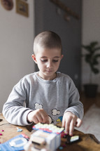 Little boy playing with lego blocks.