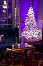 holiday christmas lounge area lights on a white Christmas tree