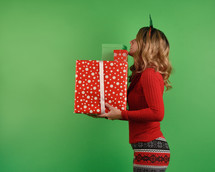 A teen girl carrying Christmas gifts 
