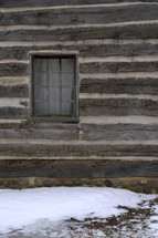 Window in a log cabin during the winter.
