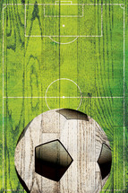 soccer ball and field on a wooden sign 