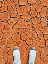 man standing on parched earth