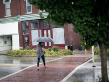 a woman carrying an umbrella in the rain 