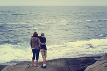 mother and son looking out at the ocean 