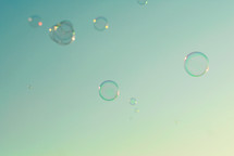 Bubbles floating against the blue sky.