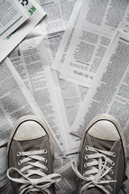 pair of shoes on top of newspaper. 