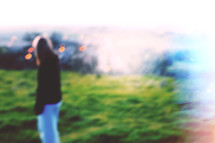 blurry image of woman outdoors 