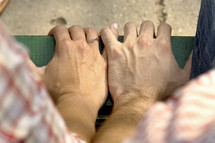 a couple holding hands in prayer 