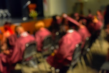 out of focus graduates in rows at graduation 