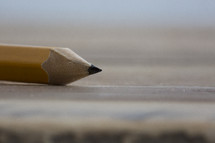 close up of a pencil on a desk.