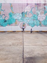 flowers painting on a wall and mother and son 