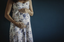a woman holding a baby bump 