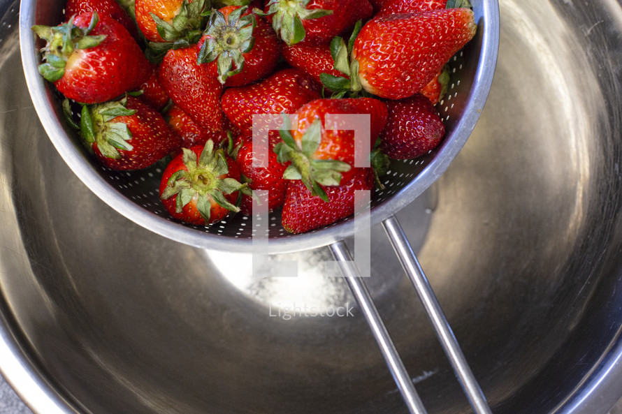 strawberries in a colander 