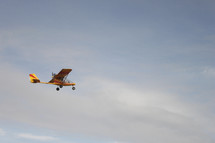small plane flying in the sky