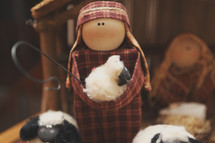 a hand made nativity scene - a shepherd and some sheep