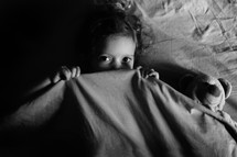 a child in bed with a teddy bear 
