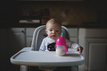a baby sitting in a high chair 