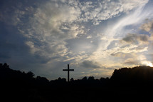silhouette of a cross in the sky 