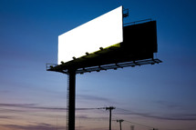 a blank billboard sign at sunset 