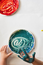 red and blue finger paint on paper plates 