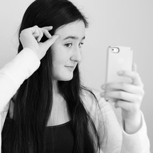 Teen girl, posing with her iPhone