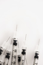 Hypodermic needles on a white background.