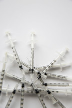 A pile of hypodermic needles.