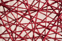 close up of criss-crossing red string.