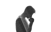 silhouette of a man in prayer with Bible pages overlapping 