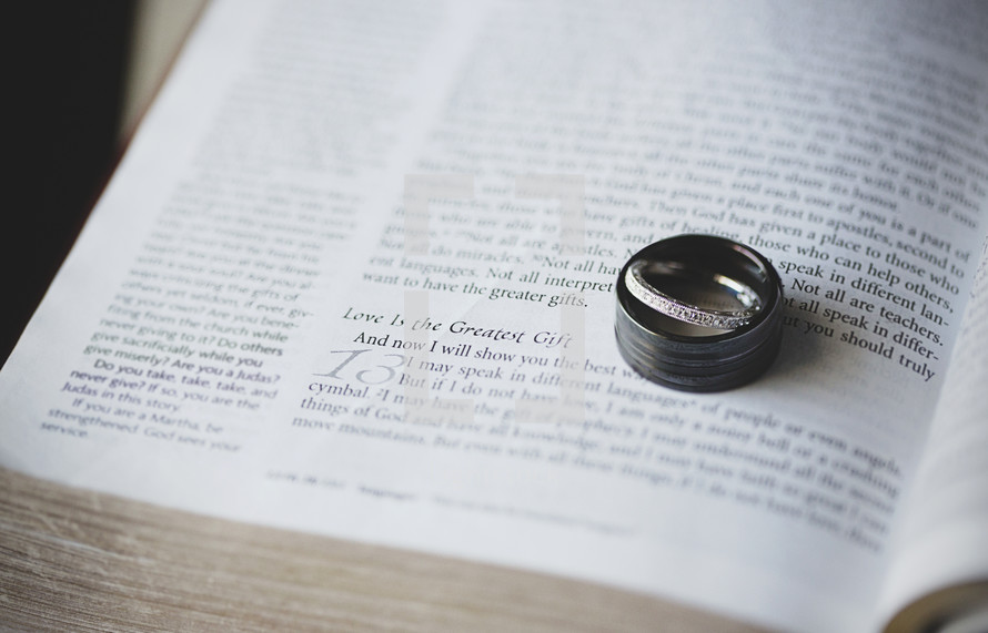 Wedding bands resting on the pages of a Bible 