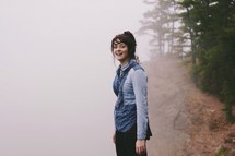 woman standing in fog 