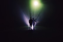 couple standing under a spotlight 