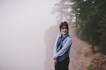 woman standing in the fog 