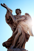 statue of an angel holding a cross