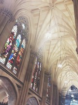 stained glass windows and arched ceiling in a cathedral 