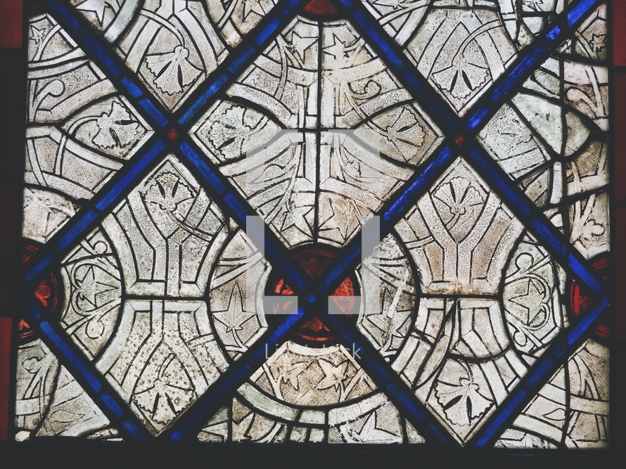 red, blue, and white pattern on a stained glass window 