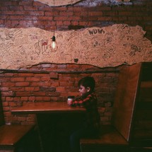 child sitting at a booth at a restaurant 