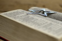 A star on an open Bible. 