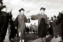 clapping for graduates at a high school graduation 
