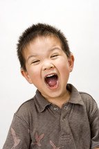 A toddler boy yelling 