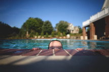a child in a goggles in a swimming pool 