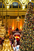 large Christmas tree and teddy bears in a hotel lobby december fireplace
