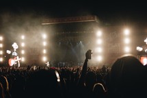 silhouettes of members of an audience at a concert 
