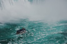 a ferry near a waterfall 