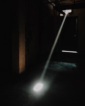light shining through a crack into a dark room 