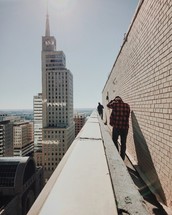 people walking on the roof of a city building 