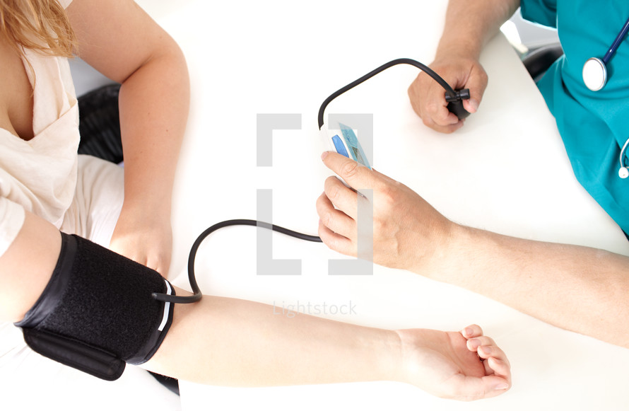 Professional check of blood pressure in a medical study.