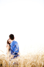 Happy couple embracing in wheat field